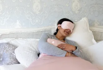 Woman sleeping wearing sleep mask
