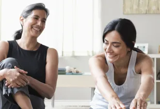 Women sitting on exercise mats and stretching